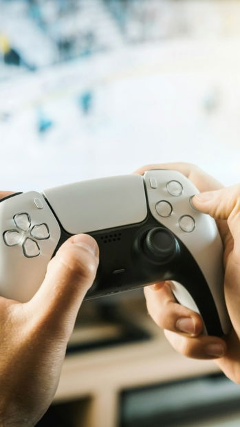 person holding black game controller